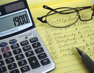 home budget on notepad with calculator and pen